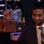 Tom Haverford Looks up and smiles