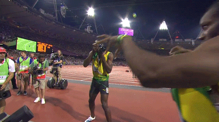 Usain-Bolt-taking-pictures-of-teammate-after-winning-gold-medal.gif