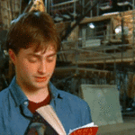 Daniel Radcliffe Looking Up From Harry Potter BOok