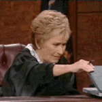 Judge Judy Opening up Laptop Slowly