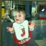 Kid Wiping Face on Glass Door