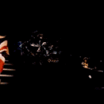 Freddie Mercury Walking Across Stage With Flag