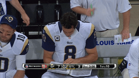 Sam-Bradford-Reads-Playbook-and-Shakes-His-Head.gif