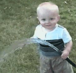 Baby-Trying-to-Drink-Out-of-Water-Hose.g